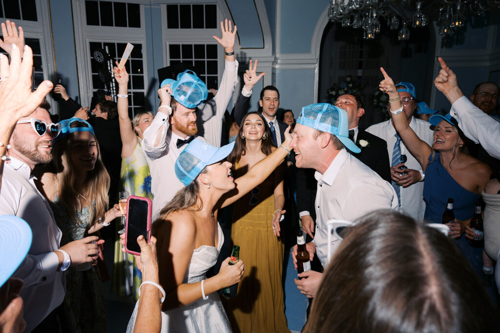 Elegant wedding reception at the Grand Galvez in Galveston, Texas featuring lush florals, soft blue details, and joyful celebration