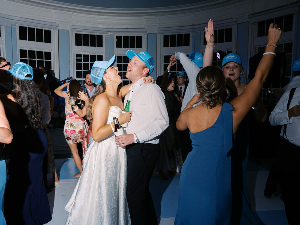 Elegant wedding reception at the Grand Galvez in Galveston, Texas featuring lush florals, soft blue details, and joyful celebration