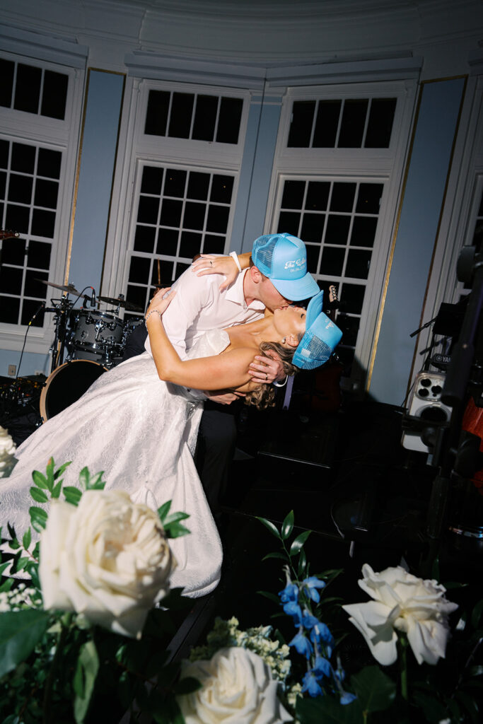 Elegant wedding reception at the Grand Galvez in Galveston, Texas featuring lush florals, soft blue details, and joyful celebration