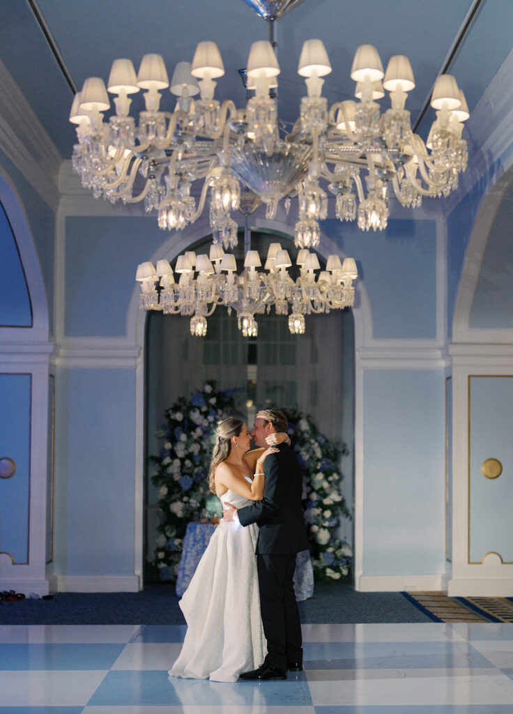 Elegant wedding reception at the Grand Galvez in Galveston, Texas featuring lush florals, soft blue details, and joyful celebration